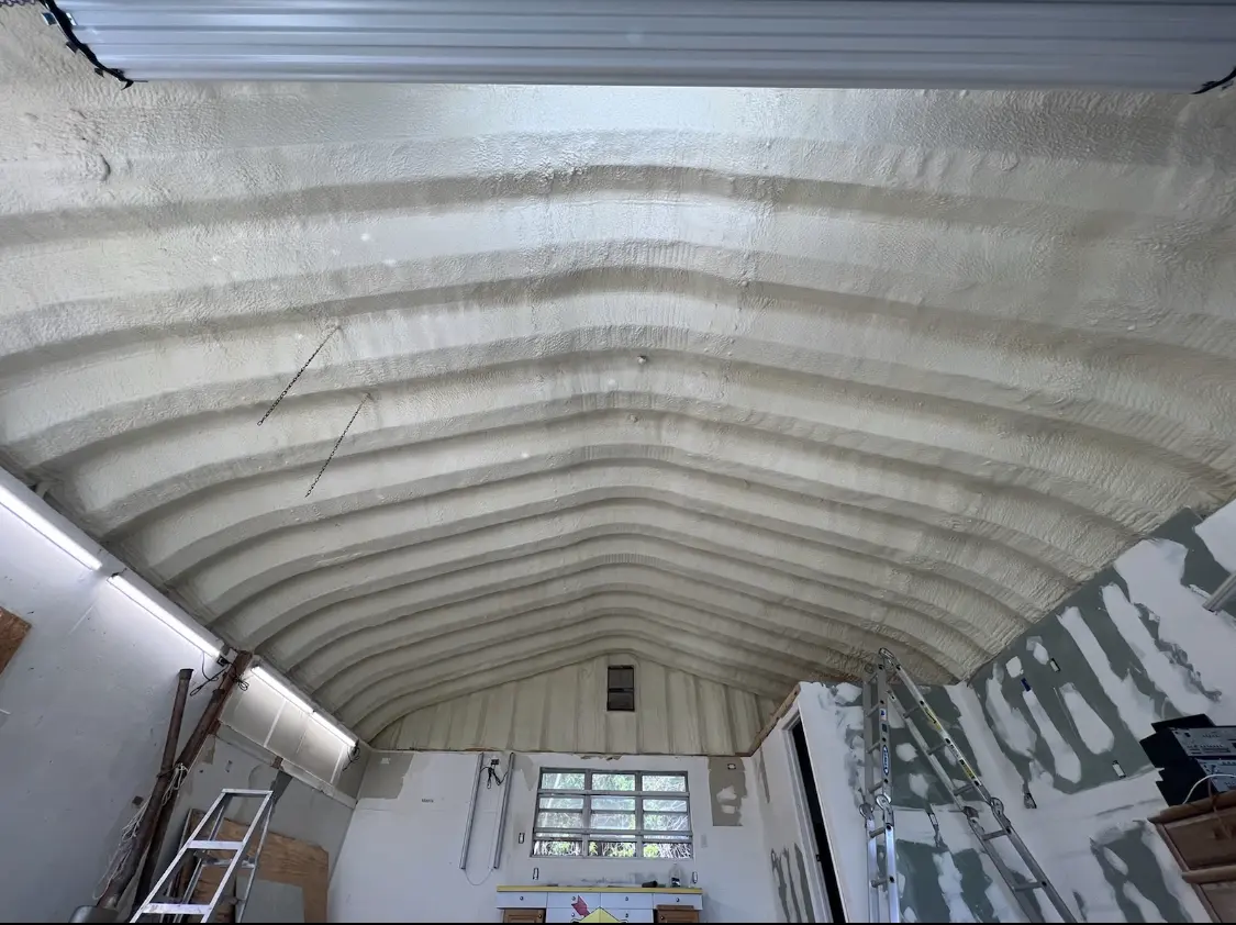 Spray polyurethane foam applied to the underside of a metal roof deck in Woodcrest